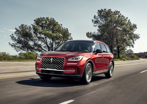A 2024 Lincoln Corsair® SUV is shown being driven on a country road. | Vision Lincoln in Wahpeton ND